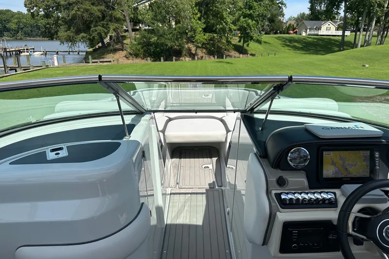 Slide: The Image of 2021 Crownline Eclipse E305 XS boat interior with Garmin navigation system, dockside view. - 22