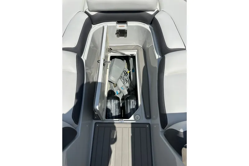Slide: The Image of 2021 Crownline Eclipse E305 XS boat storage compartment with various items inside. - 33