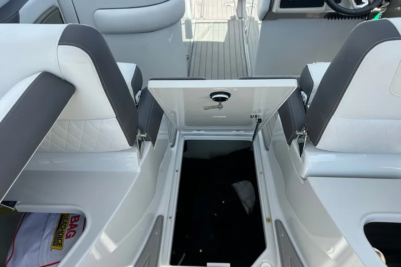 Slide: The Image of 2021 Crownline Eclipse E305 XS boat interior with open storage compartment. - 19
