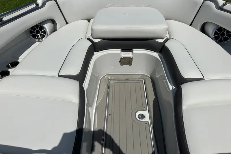 Slide: The Image of 2021 Crownline Eclipse E305 XS boat interior with white cushioned seating and speakers. - 32
