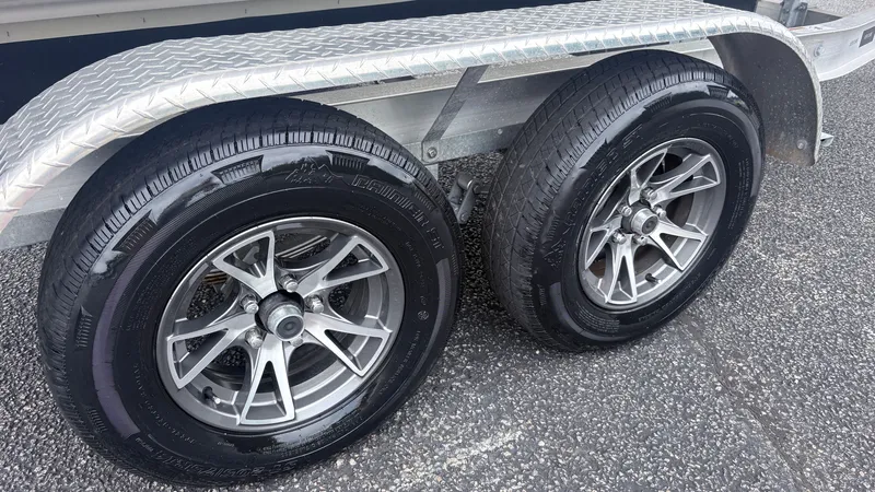 Slide: The Image of A tandem axle trailer with two pairs of tires and a textured metal fender. - 6
