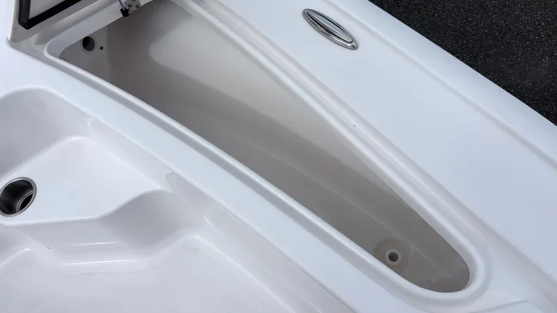 Slide: The Image of Close-up of a white boat storage compartment with an oval handle. - 16