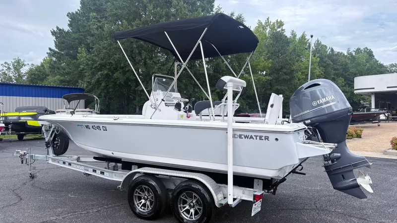 Slide: The Image of A white 2024 Tidewater 1910 Bay Max boat on a trailer, featuring a black sunshade. - 4