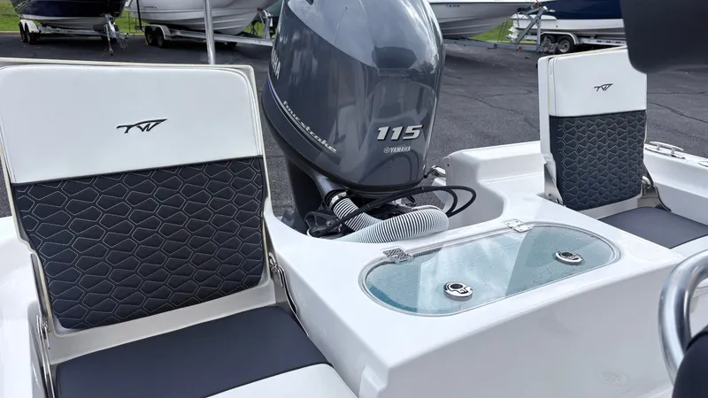 Slide: The Image of The image shows the cockpit of a 2024 Tidewater 1910 Bay Max boat with a Yamaha 115 engine. - 7