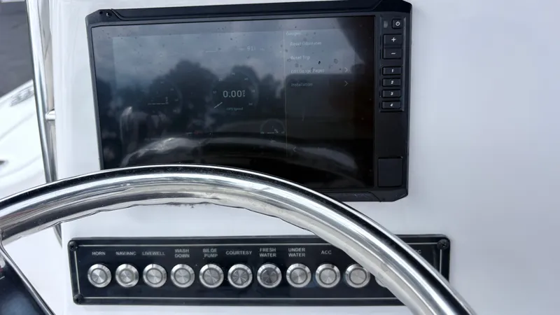 Slide: The Image of The image shows the helm of a 2024 Tidewater 1910 Bay Max boat with a modern display and switches. - 11