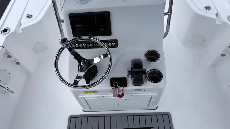 Slide: The Image of The image shows the helm of a 2024 Tidewater 1910 Bay Max boat with a steering wheel and controls. - 10