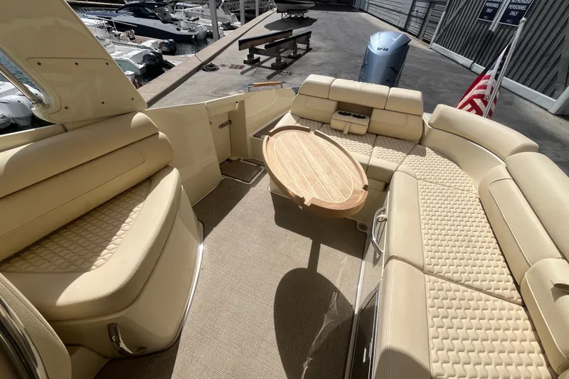 Slide: The Image of Luxurious interior of 2019 Chris-Craft Launch GT 28 boat with beige seating and wooden table. - 18
