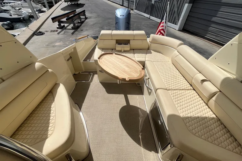 Slide: The Image of Luxurious 2019 Chris-Craft Launch GT 28 boat interior with elegant beige seating and wooden table. - 19