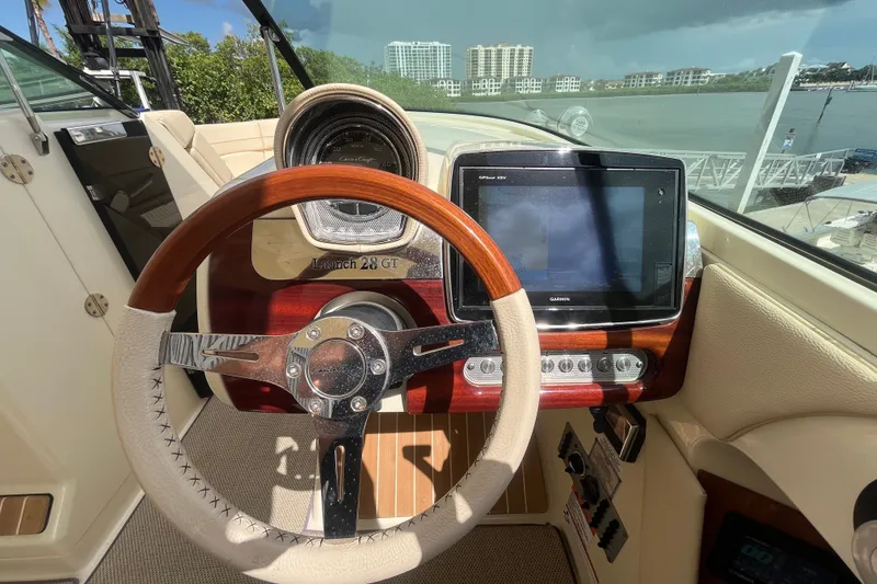 Slide: The Image of 2019 Chris-Craft Launch GT 28 dashboard with steering wheel and navigation display. - 23