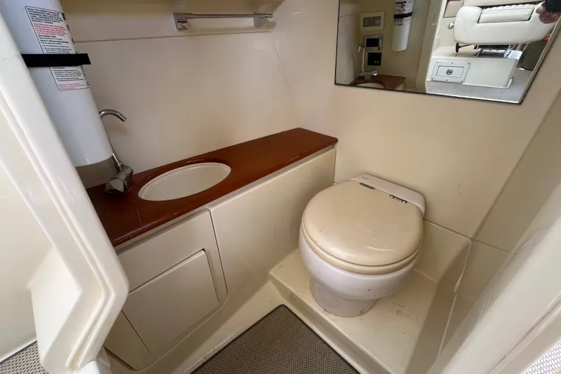 Slide: The Image of 2019 Chris-Craft Launch GT 28 boat bathroom with sink, toilet, and mirror. - 15