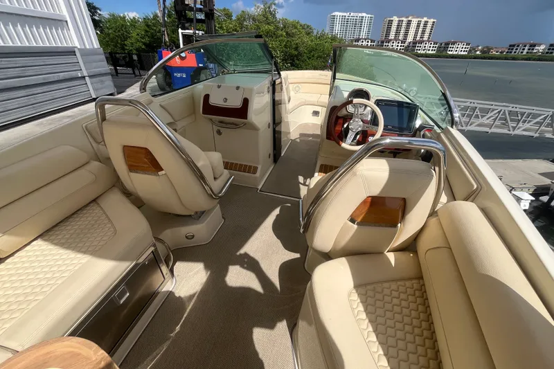 Slide: The Image of 2019 Chris-Craft Launch GT 28 interior with luxurious beige seating and modern dashboard. - 20