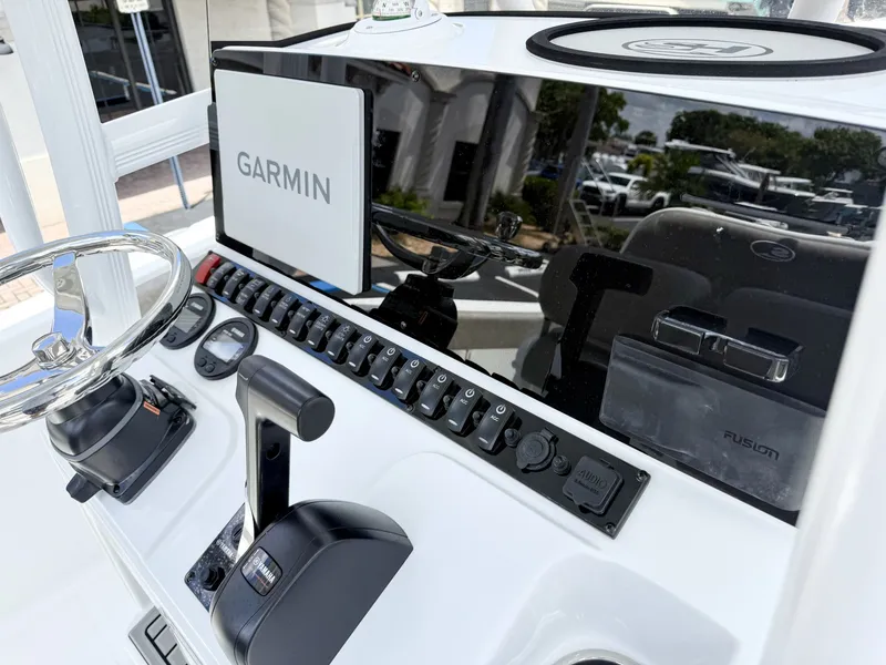 Slide: The Image of The image shows the helm of a Sea Hunt Ultra 229 boat with Garmin navigation. - 19