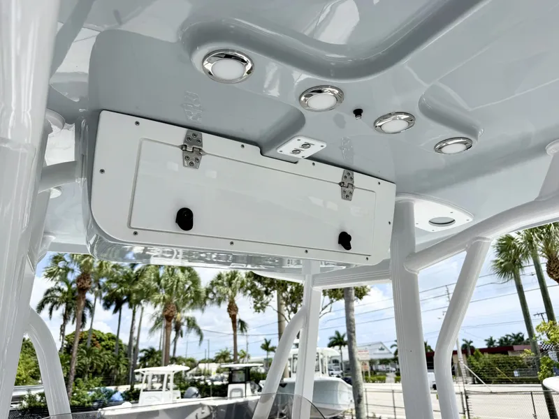 Slide: The Image of The image shows the roof of a Sea Hunt Ultra 229 boat with built-in lights and a storage compartment. - 20