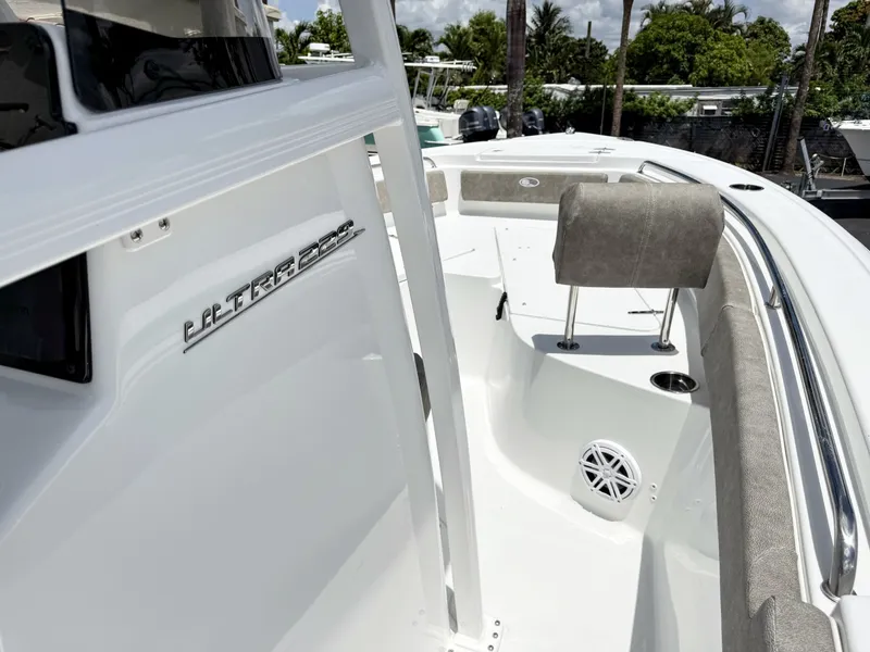 Slide: The Image of The image shows the deck of a Sea Hunt Ultra 229 boat with gray upholstery and speakers. - 21