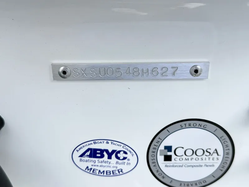 Slide: The Image of Close-up of a boat hull with a serial number and two stickers. - 30