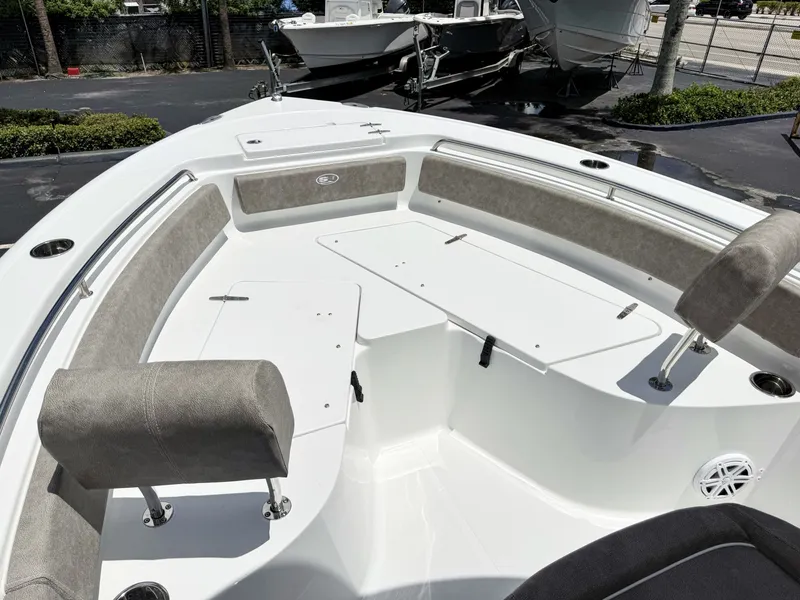 Slide: The Image of The image shows the bow area of a Sea Hunt Ultra 229 boat with cushioned seats and storage. - 25