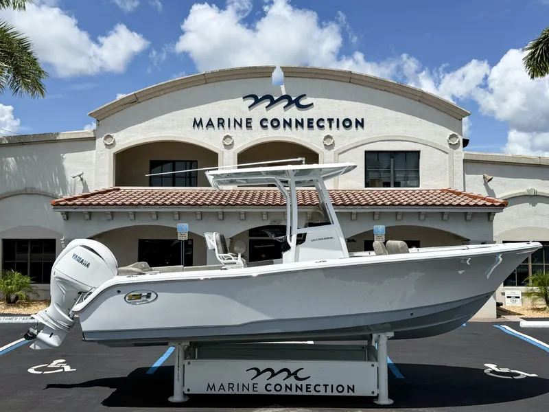 The Image of A 2027 Sea Hunt Ultra 229 boat is displayed in front of a building labeled "Marine Connection." - 1