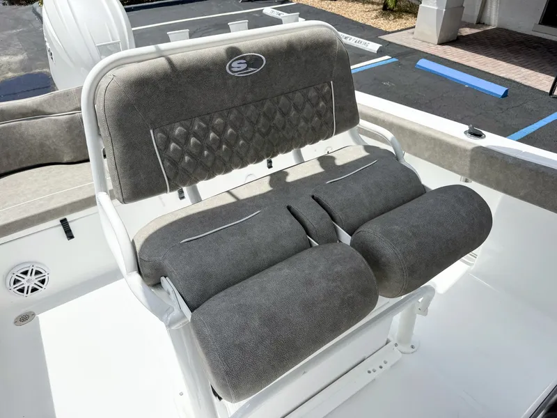 Slide: The Image of The 2027 Sea Hunt Ultra 229 features a cushioned bench seat with gray upholstery. - 16