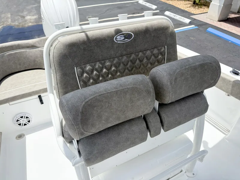 Slide: The Image of The 2027 Sea Hunt Ultra 229 features cushioned seats with gray fabric and a quilted pattern. - 15