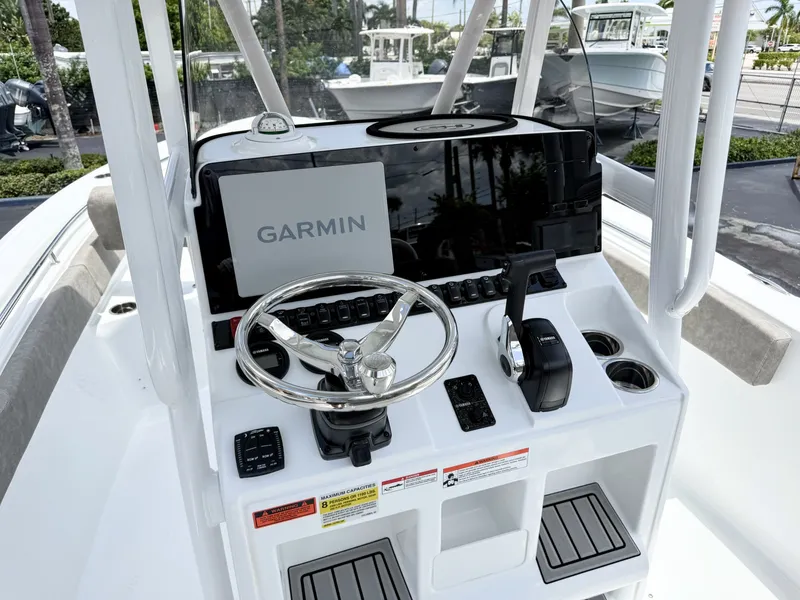Slide: The Image of The image shows the helm of a Sea Hunt Ultra 229 boat with a Garmin navigation system. - 17