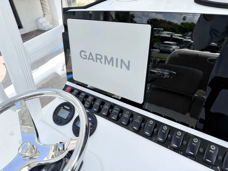 Slide: The Image of The image shows the helm of a Sea Hunt Ultra 229 boat with a Garmin display. - 18