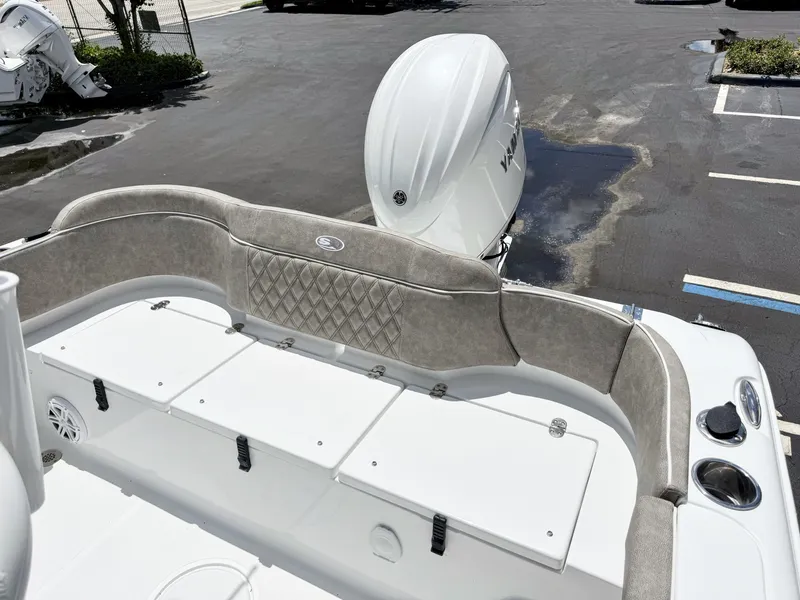 Slide: The Image of The image shows the stern of a Sea Hunt Ultra 229 boat with cushioned seating and storage. - 9