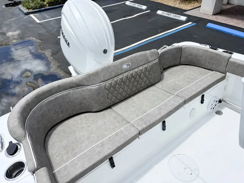 Slide: The Image of The image shows the stern of a Sea Hunt Ultra 229 boat with gray cushioned seating. - 12