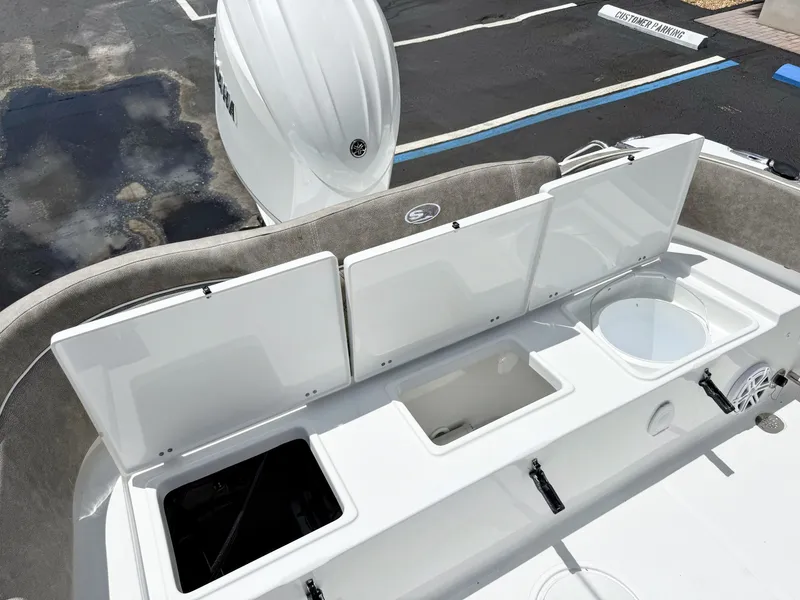 Slide: The Image of The image shows the stern of a Sea Hunt Ultra 229 boat with open storage compartments. - 10