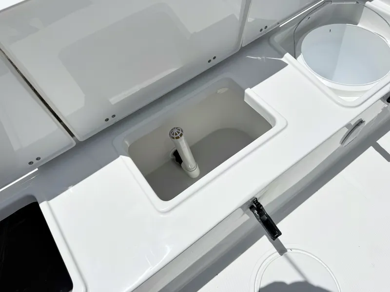 Slide: The Image of The image shows the deck of a Sea Hunt Ultra 229 boat with an open storage compartment. - 11