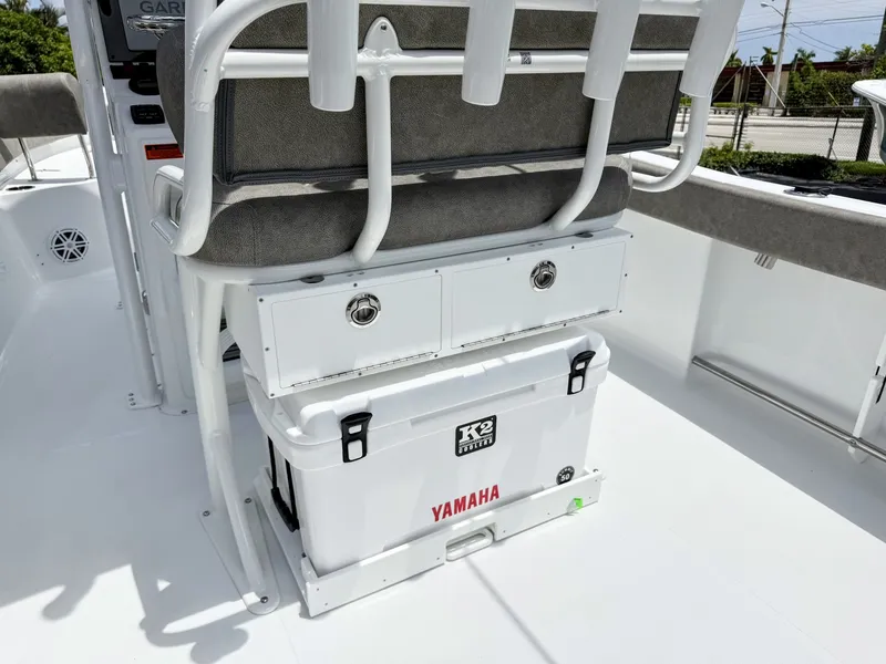 Slide: The Image of The image shows the seating area of a Sea Hunt Ultra 229 boat with a Yamaha cooler underneath. - 13