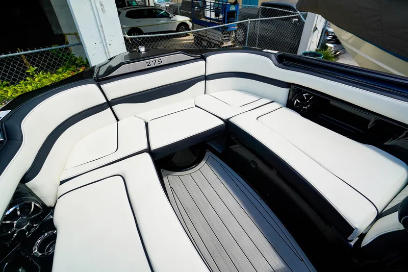 Slide: The Image of Luxurious seating area on the 2025 Yamaha Boats 275SD, featuring sleek white upholstery. - 21