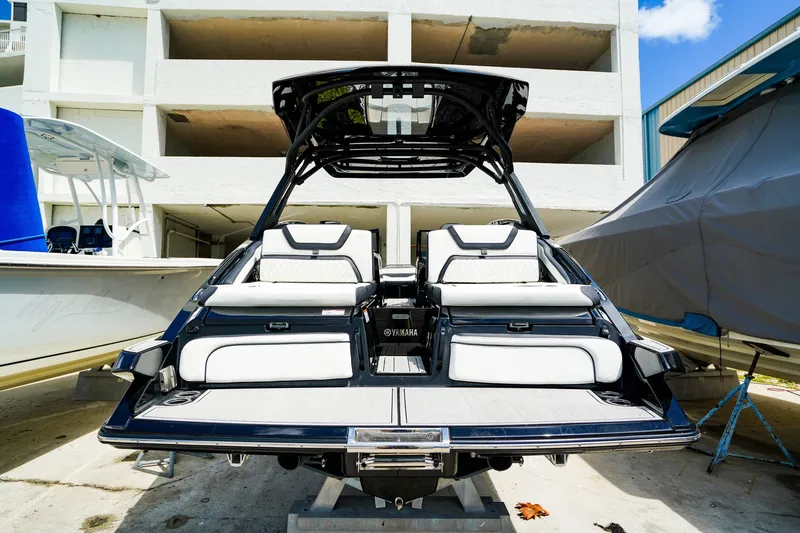 Slide: The Image of 2025 Yamaha Boats 275SD, sleek design, luxury seating, docked outdoors. - 27