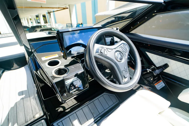 Slide: The Image of Interior view of 2025 Yamaha Boats 275SD, featuring sleek steering wheel and modern dashboard. - 18