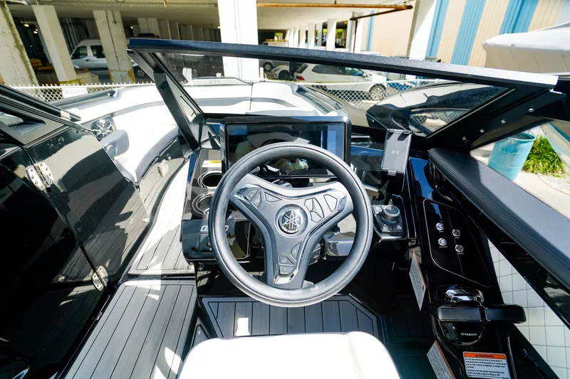 Slide: The Image of 2025 Yamaha Boats 275SD cockpit with steering wheel and modern controls. - 19