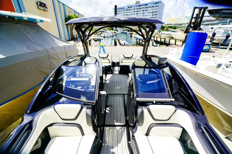 Slide: The Image of 2025 Yamaha Boats 275SD interior view at marina, showcasing sleek design and seating. - 23