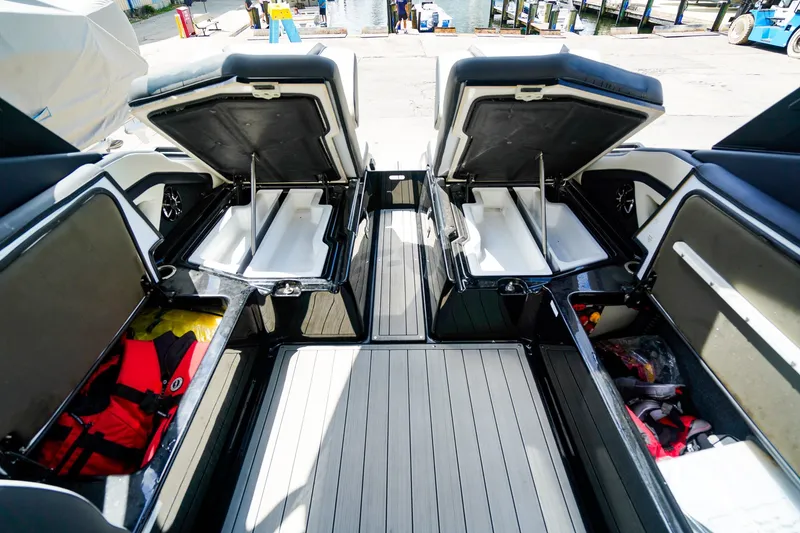 Slide: The Image of 2025 Yamaha Boats 275SD storage compartments open, showcasing spacious interior and organized gear. - 13