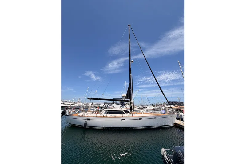 Slide: The Image of 2003 Farr 50 Pilot House sailboat docked in a marina under a clear blue sky. - 6