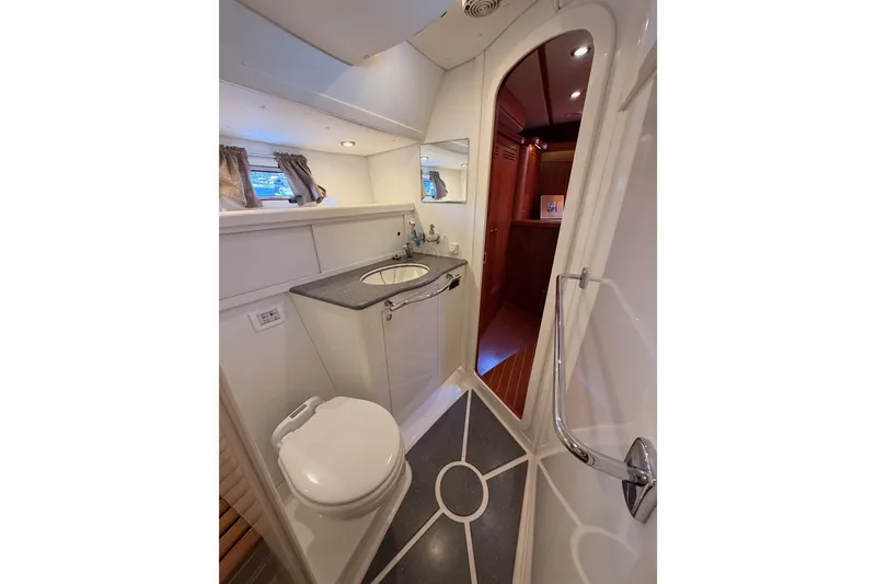 Slide: The Image of Bathroom interior of 2003 Farr 50 Pilot House yacht, featuring sink and toilet. - 116