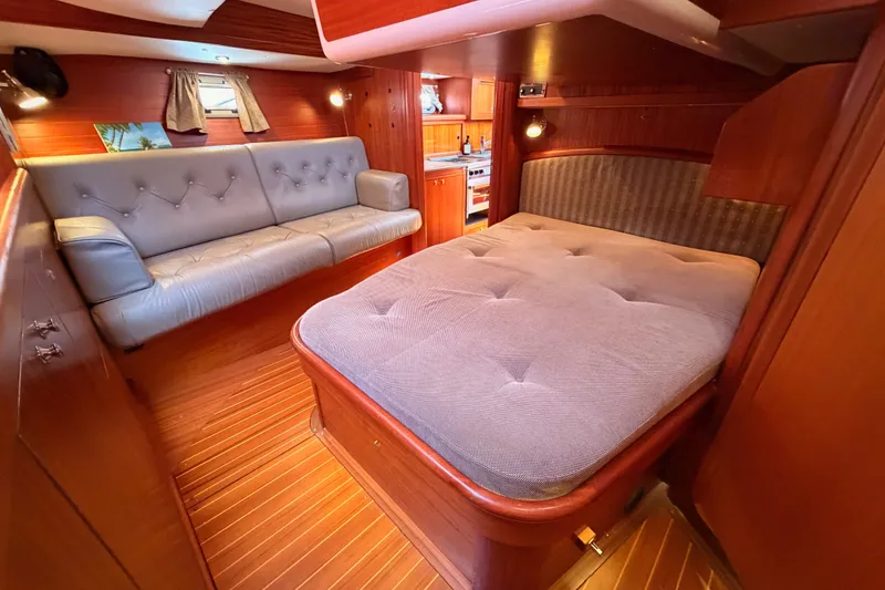 Slide: The Image of Luxurious interior of 2003 Farr 50 Pilot House yacht with cozy bed and seating area. - 119