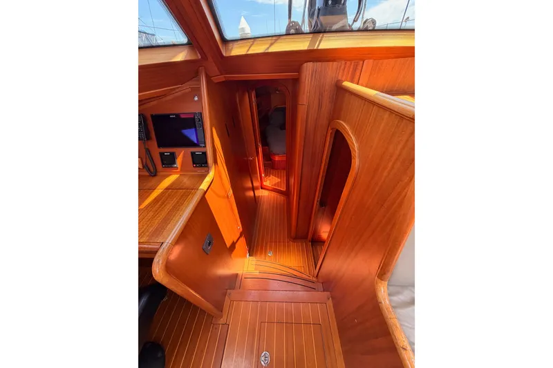 Slide: The Image of Interior of 2003 Farr 50 Pilot House yacht with polished wood finish and navigation equipment. - 73