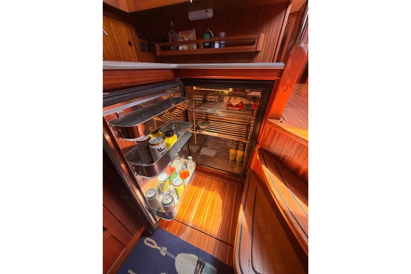 Slide: The Image of Open fridge in 2003 Farr 50 Pilot House yacht kitchen, stocked with beverages and food. - 98
