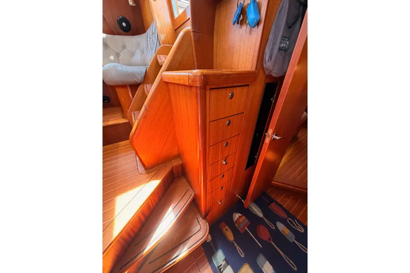 Slide: The Image of Interior of 2003 Farr 50 Pilot House with wooden stairs and storage drawers. - 103
