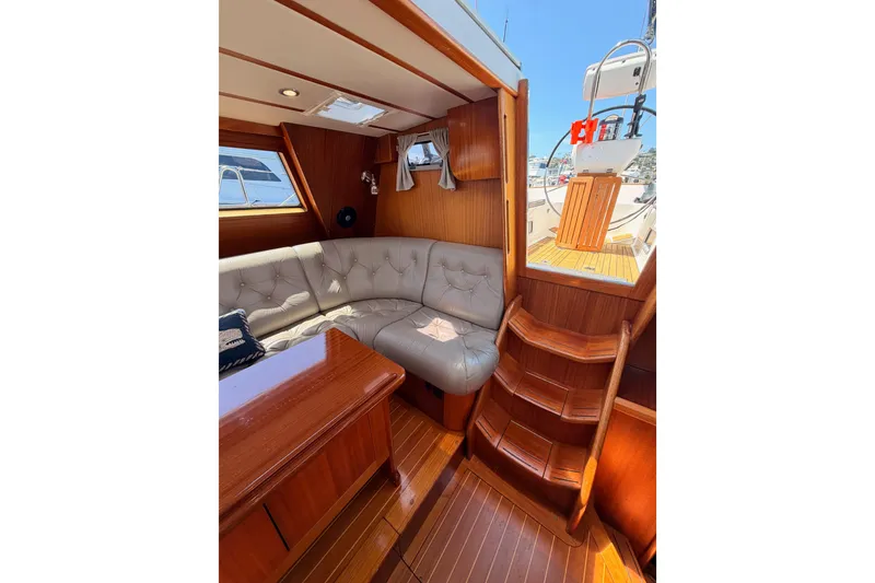 Slide: The Image of Luxurious interior of 2003 Farr 50 Pilot House yacht with plush seating and wooden finishes. - 59