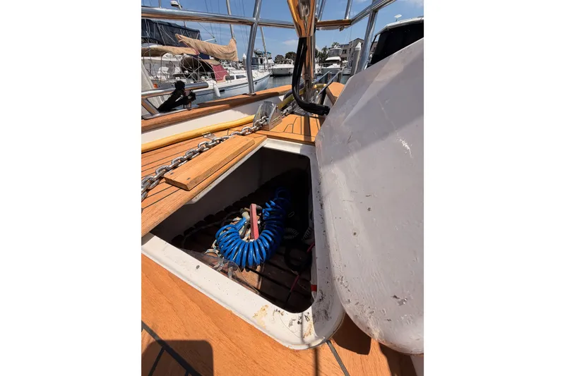 Slide: The Image of Open hatch on 2003 Farr 50 Pilot House sailboat deck, revealing storage compartment. - 25