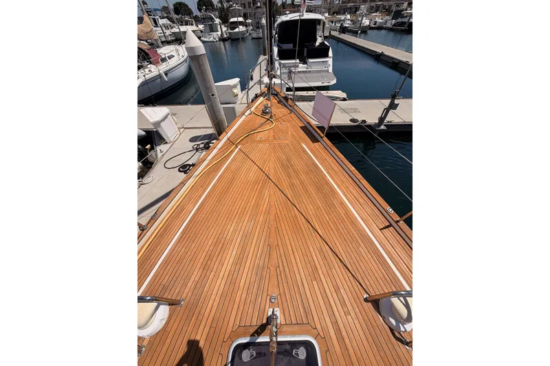 Slide: The Image of Deck view of a 2003 Farr 50 Pilot House yacht docked at a marina. - 23