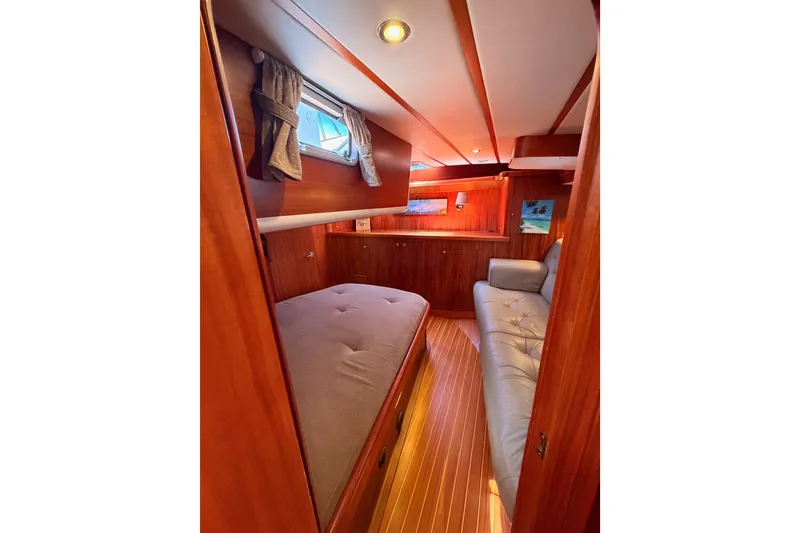 Slide: The Image of Cozy interior of 2003 Farr 50 Pilot House yacht with wooden finishes and comfortable seating. - 105