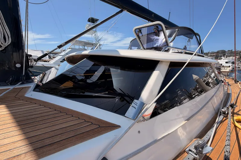 Slide: The Image of 2003 Farr 50 Pilot House yacht with sleek design, docked at marina under clear blue sky. - 18