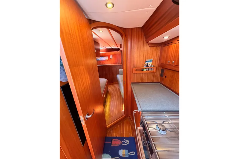 Slide: The Image of Interior of 2003 Farr 50 Pilot House yacht with wooden cabinetry and modern amenities. - 104