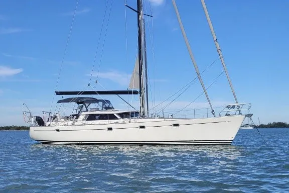 Slide: The Image of 2003 Farr 50 Pilot House sailboat on calm water under clear blue sky. - 4