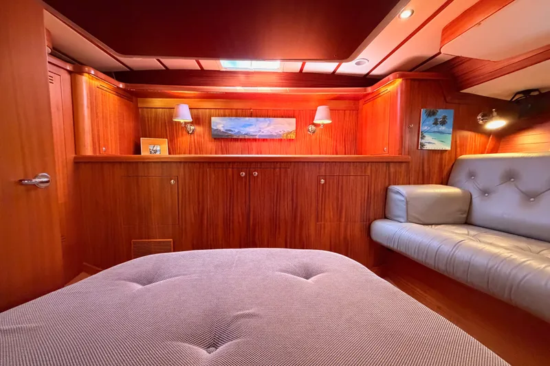 Slide: The Image of Luxurious interior of a 2003 Farr 50 Pilot House yacht with wood paneling and cozy seating. - 108